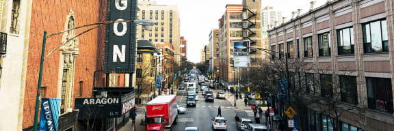a busy city street with cars and buildings