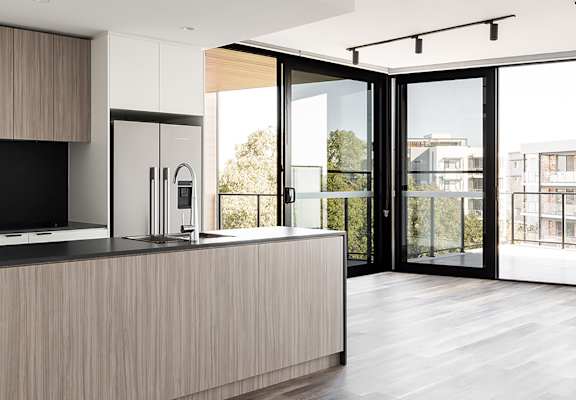 a kitchen with a large island and sliding glass doors