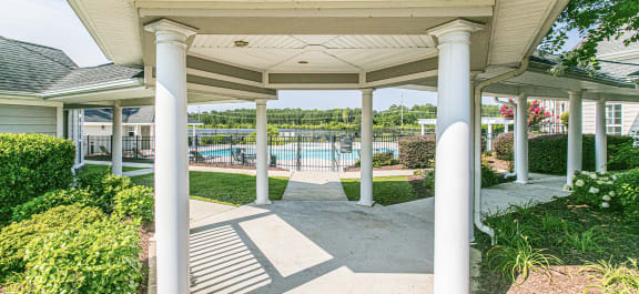 a covered walkway leading to a pool at Village on the Lake Apartments, Spring Lake, NC