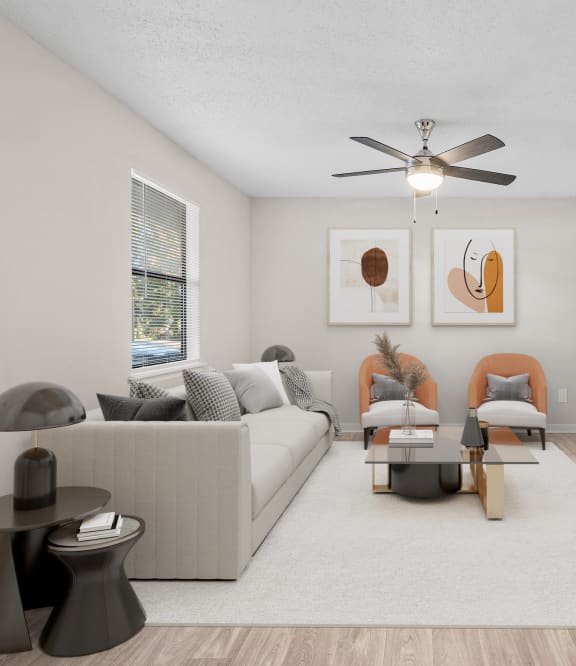 a living room with three mirrors and a wood floor