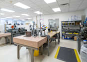 Thumbnail 2 of 21 - A clean, well-lit workshop with tables and various equipment.
