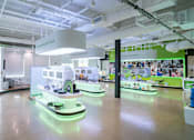 Thumbnail 5 of 21 - A room with a green and white color scheme and a sign that says "Exploring the Future".