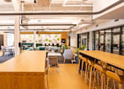 Thumbnail 6 of 21 - A conference room with a long table and chairs.