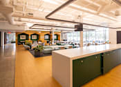 Thumbnail 7 of 21 - A long white table with green cabinets on the side.