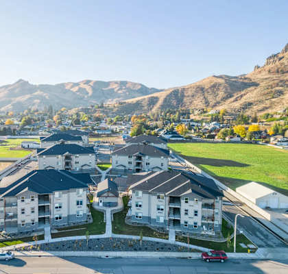 A suburban neighborhood with houses and a mountain in the background.
