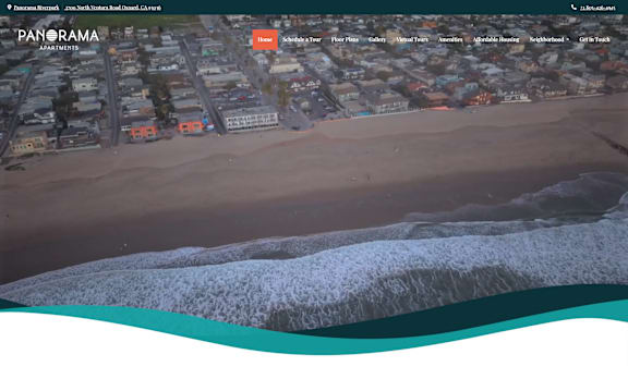 A beachfront with buildings and a frozen water body.