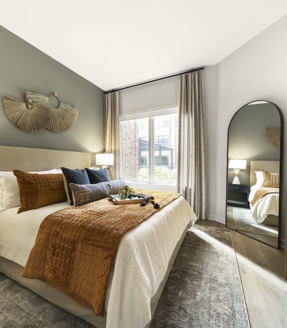 a bedroom with a large bed and a large window at The Ivy, Chatham