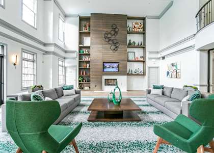 A living room with a fireplace and a TV on the wall. at The Atlantic Buckhead Apartments, Atlanta, GA, 30305