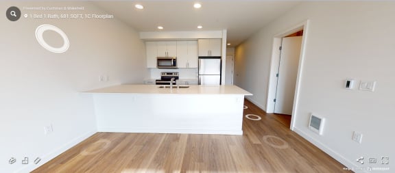 an open kitchen with a white counter top and a large island