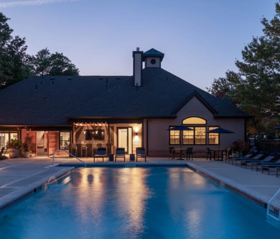 a house with a swimming pool at dusk