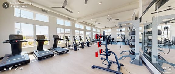 A gym with treadmills, elliptical machines, and other exercise equipment.
