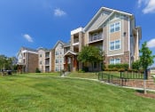 Thumbnail 13 of 18 - Glenbrook Apartments - Exterior building with manicured lawn