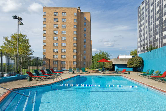Quality Hill Towers - Resort-style pool with surrounding sun deck and cabana