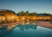 Thumbnail 18 of 18 - Versant Place Apartments resort-style pool at dusk