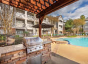 Thumbnail 13 of 18 - Lodge at Cypresswood Apartments - Poolside BBQ grills
