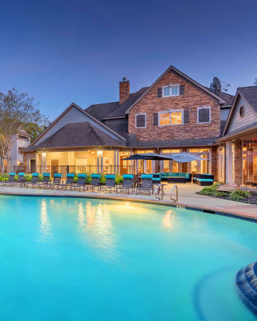 Lodge at Cypresswood Apartments - Pool with sundeck at twilight