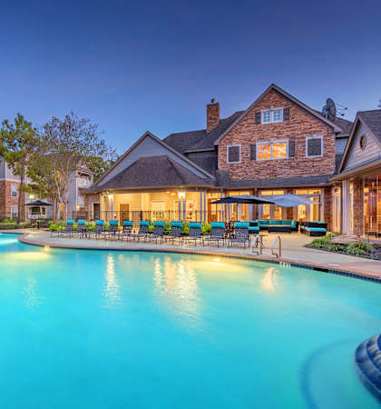 Lodge at Cypresswood Apartments - Pool with sundeck at twilight