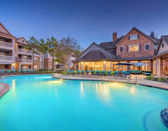 Lodge at Cypresswood Apartments - Pool with sundeck at twilight