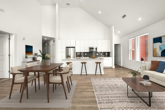 a living room and dining room with a table and chairs