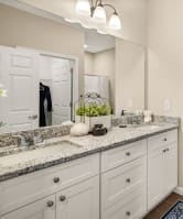 a bathroom with a toilet and a sink and a mirror