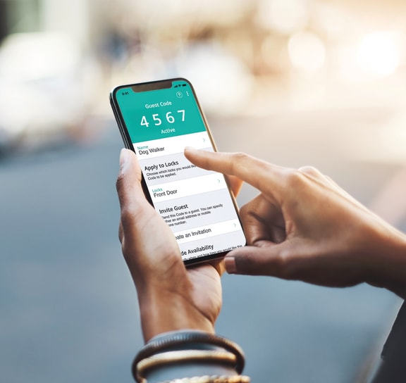 a person holding a smartphone with the uber app on the screen at Foxwood and The Hermitage, Portage, MI