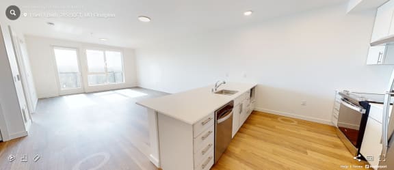a kitchen with white cabinets and a white counter top