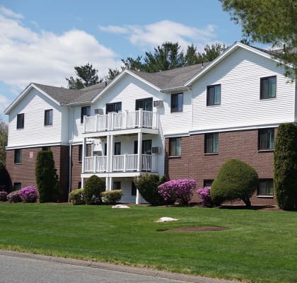 Building Exterior with Balcony and Entrance at Mansfield Meadows Apartments in Mansfield, MA.