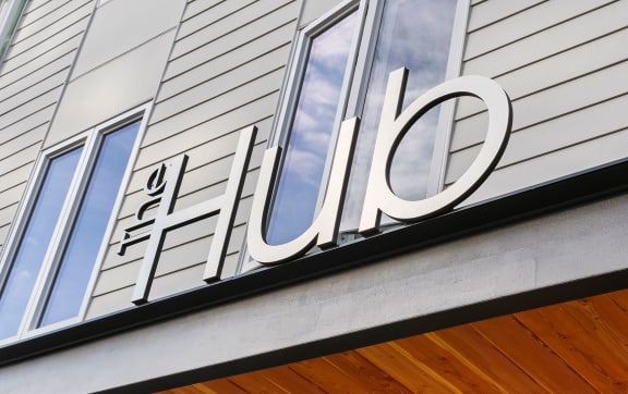 the facade of a building with a sign that reads the hotel  at The Hub, Washington, 98503