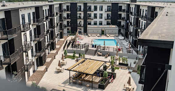 A large outdoor patio area with a pool and seating area.