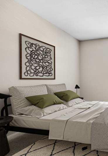 A bedroom with a bed, chair, and a plant.