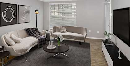 Model apartment living room with two couches and a television