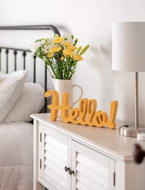 a bedroom with a bed and a table with a vase of flowers  at Emerald Bay, Charlotte, North Carolina