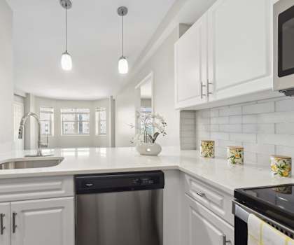 kitchen with designer pendant lighting and custom cabinetry at HighPoint luxury apartments