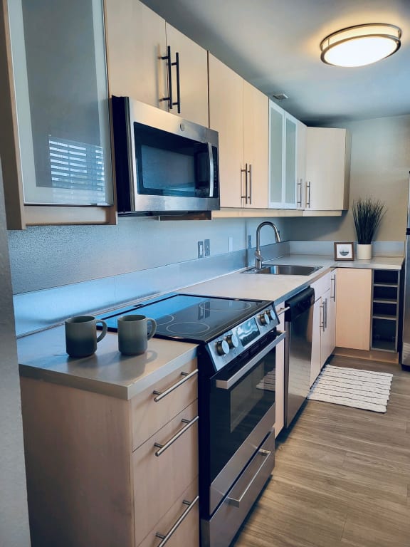a kitchen with a stove top oven next to a sink