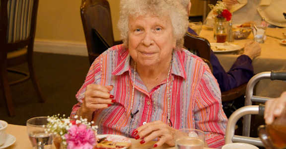Lady having food at Savannah Grand of Sarasota, Sarasota, Florida