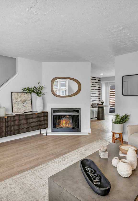 A living room with a fireplace and a couch.