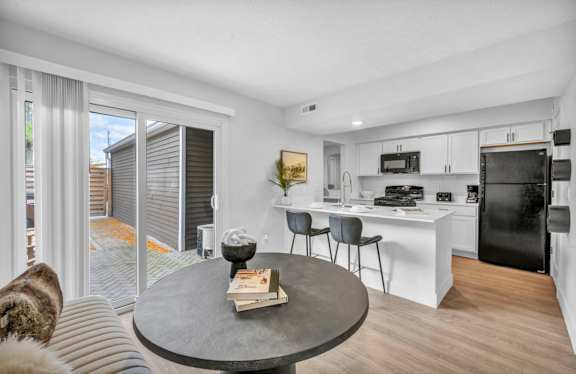 A kitchen with a white countertop and a fridge.