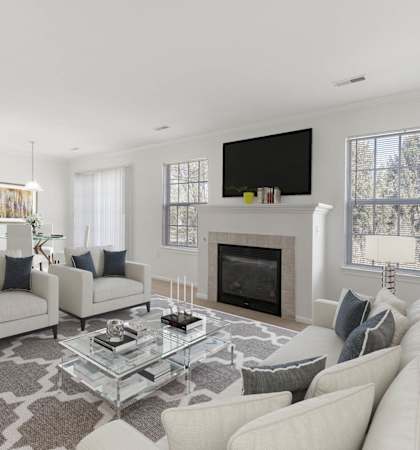 a living room filled with furniture and a flat screen tv at Brownstones, Novi, Michigan