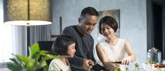 a family prepares a meal in the kitchen