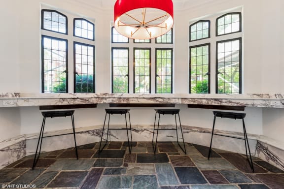 a long table with three stools in front of a row of windows at 1033 W Loyola, Chicago, IL