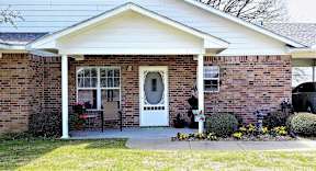 A house with a white door and a porch.