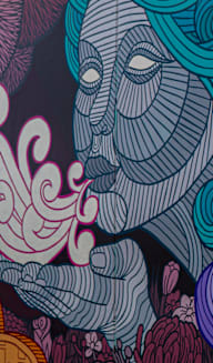 a mural with blue and purple colors on a wall