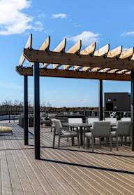 a terrace with couches and a fire pit