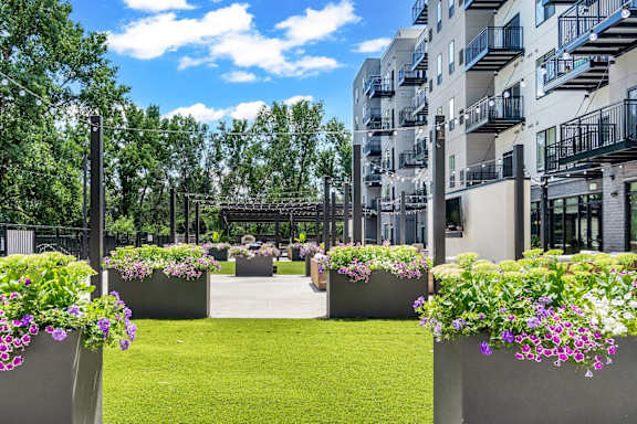 a balcony with a view of trees and a blue sky at Ardor on the Bluffs South Loop Residences Apartments, Bloomington, 55425