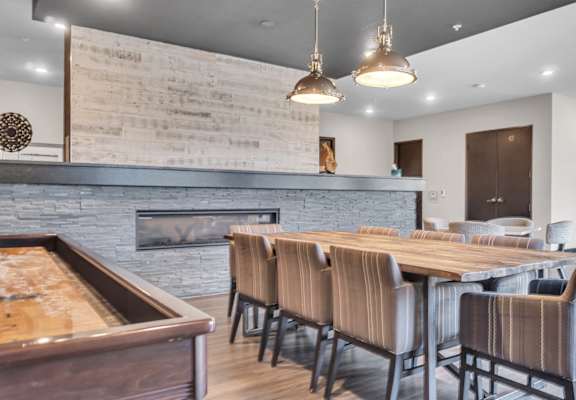 A modern dining room with a fireplace and wooden furniture.