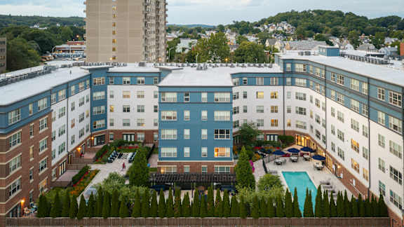 A large building with a pool in the middle of it.