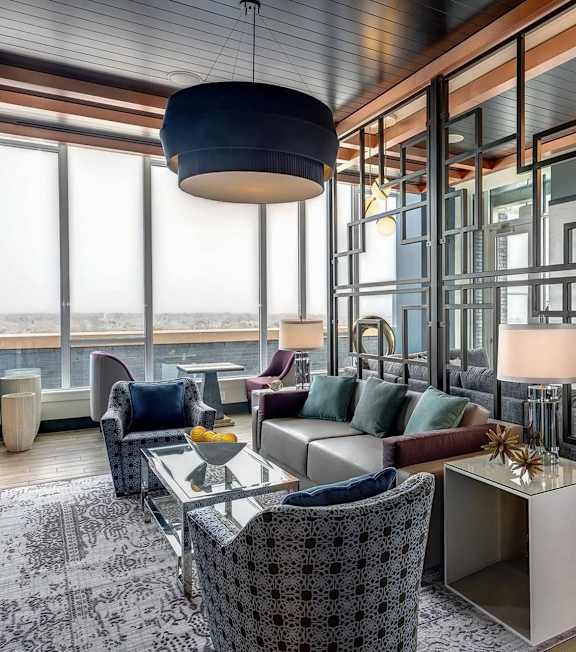 A modern living room with a large window and a view of the city.