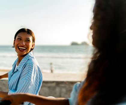 A woman is riding a bicycle on a beach.