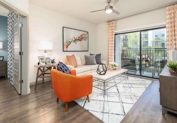 a living room with a couch and a table   and a sliding glass door