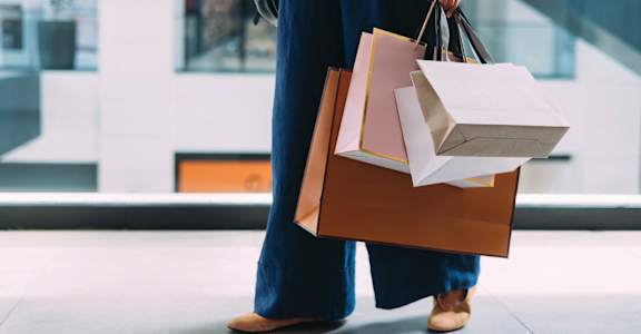 a woman carrying shopping bags and paper bags at Aura Stonebridge, Virginia, 23225